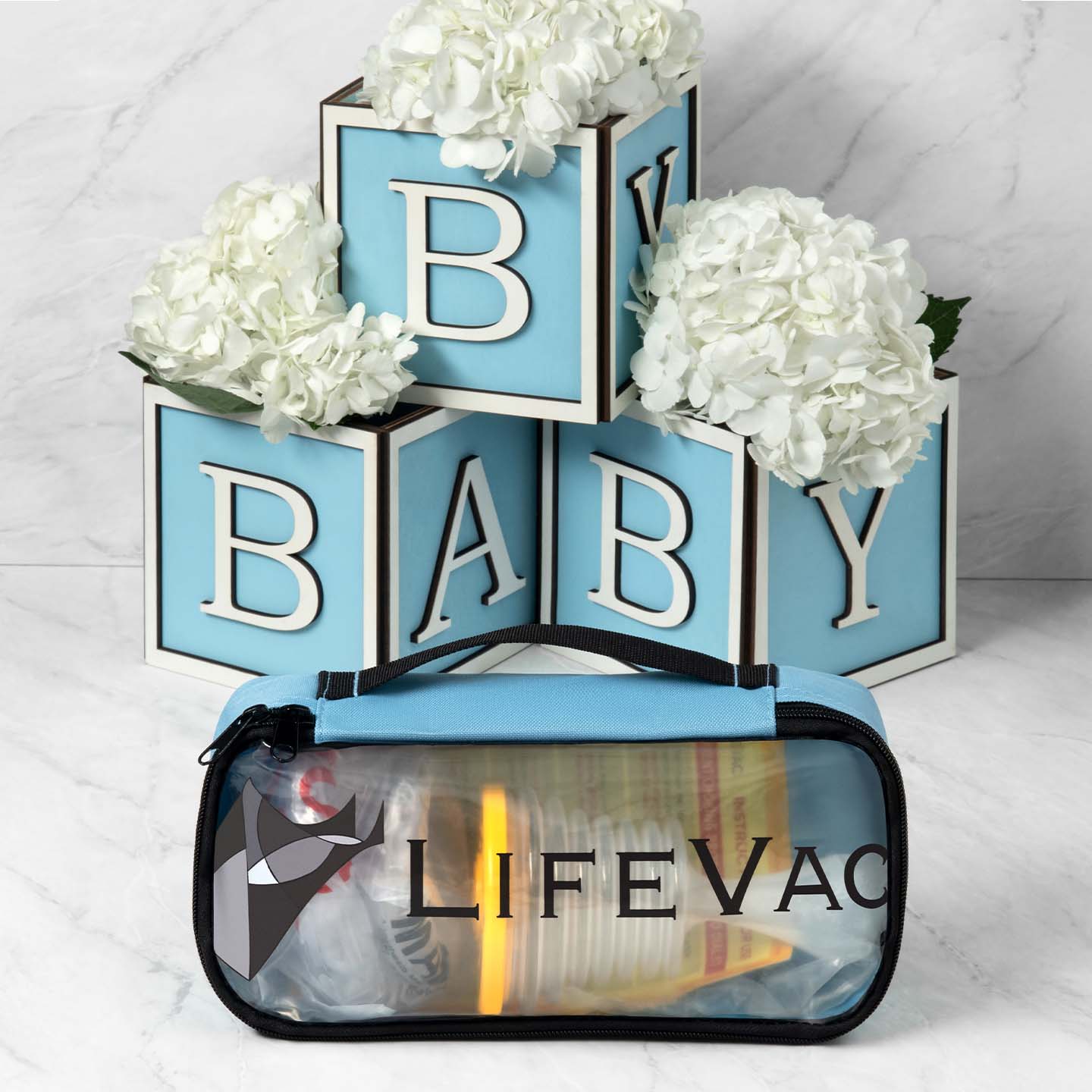 Blue LifeVac Travel Kit with baby-themed decorative blocks and flowers.